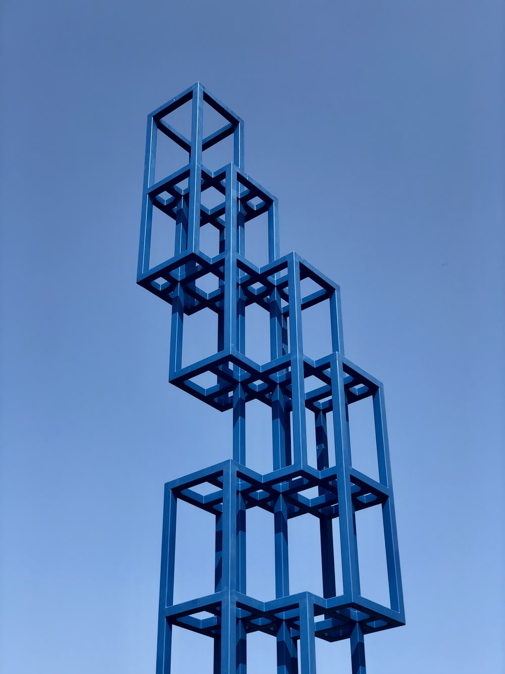 a tall metal structure with many squares on top of it
