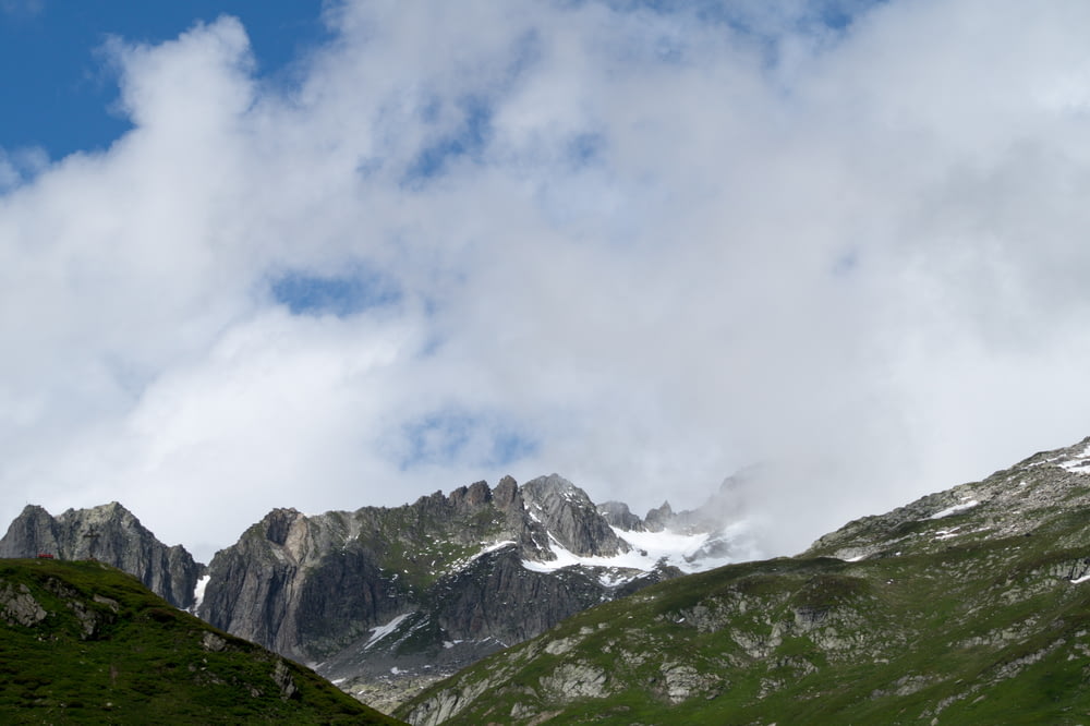 green mountains under white clouds