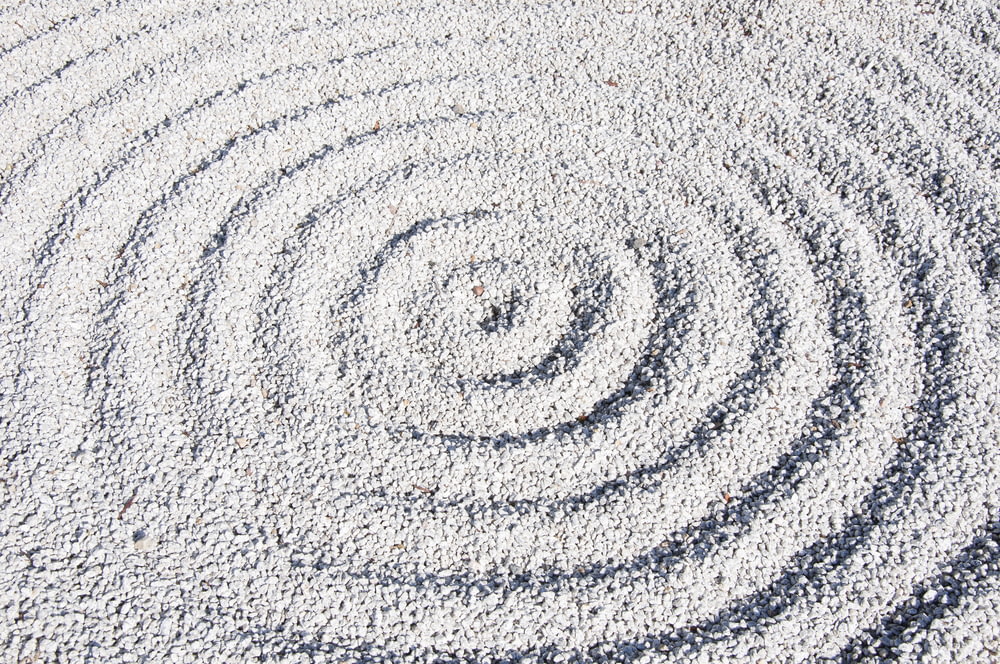 a circular design made of sand on a beach