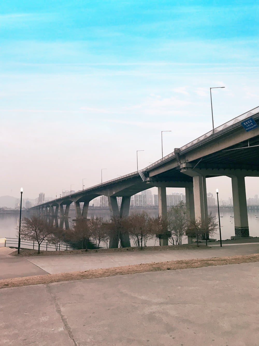 gray concrete bridge with light post