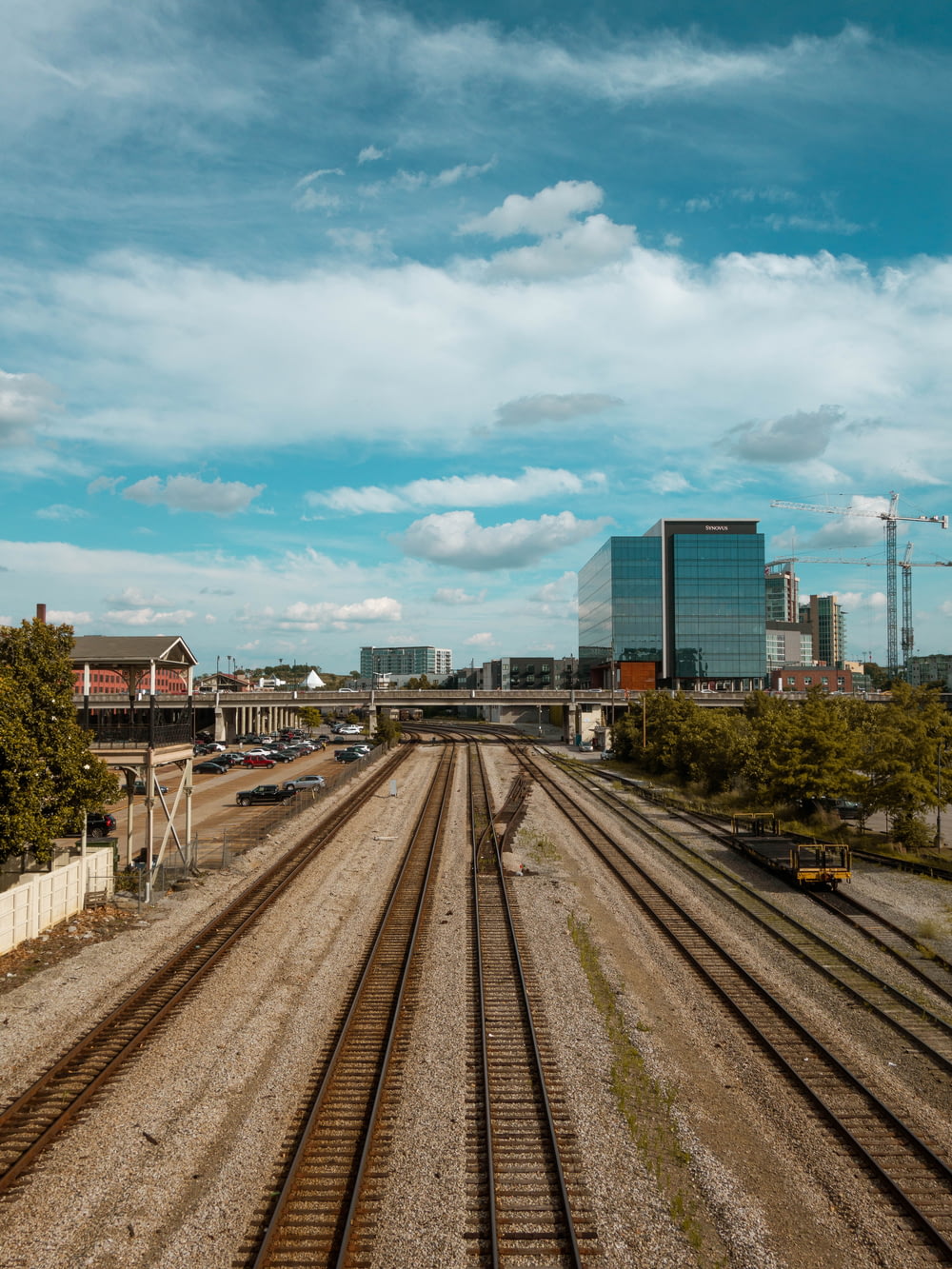 a view of a train track with buildings in the background