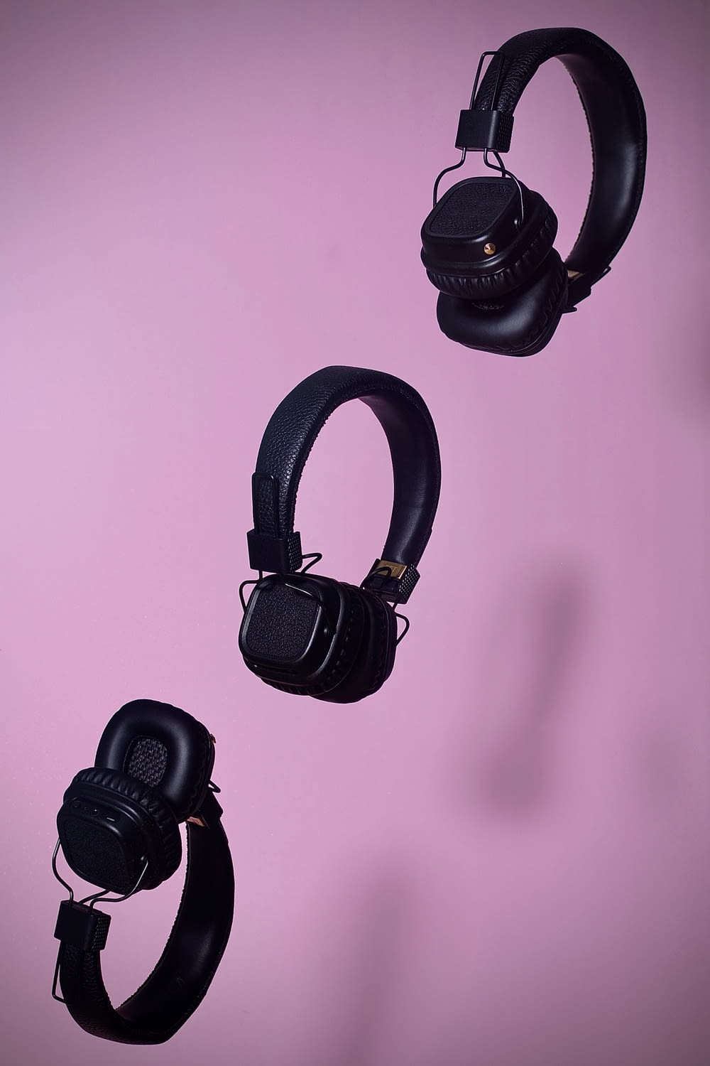 three black cordless headphones