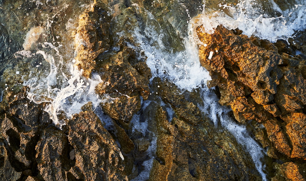 a close up of rocks with water coming out of them