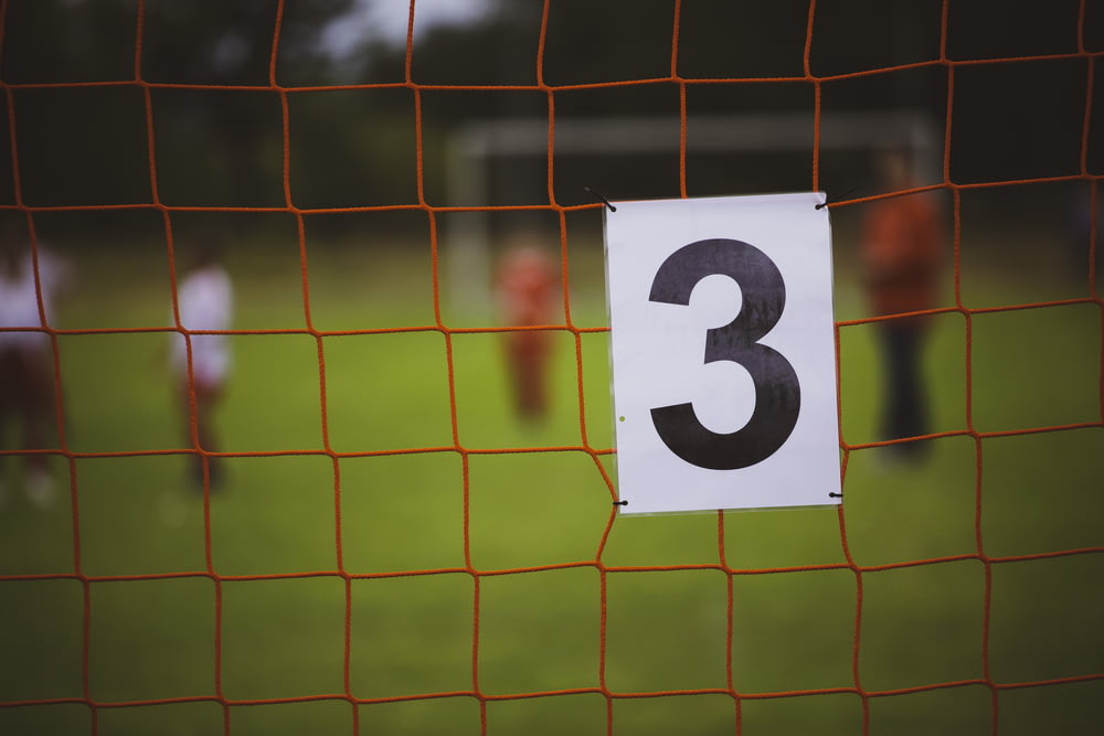 a number three sign on a soccer goal
