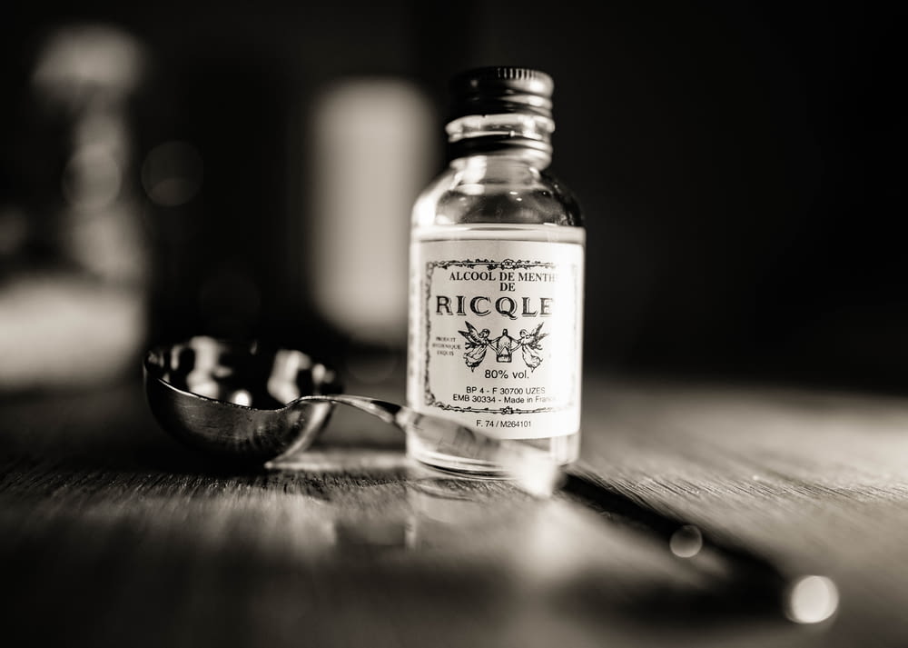 grayscale photography of glass bottle