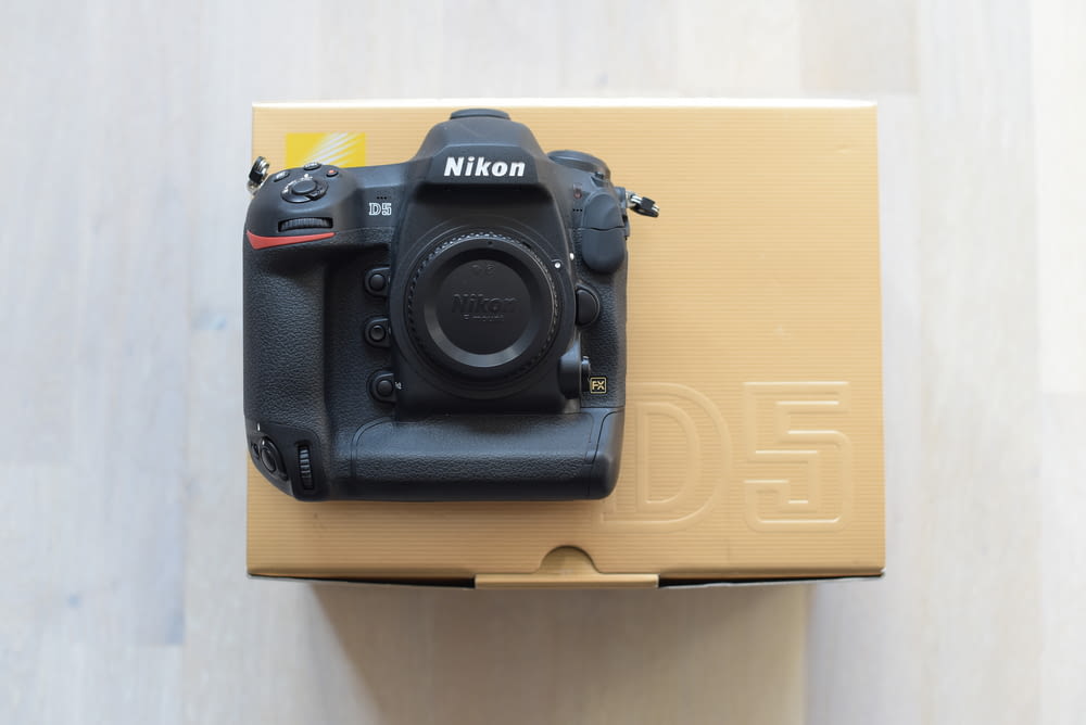 black Nikon DSLR camera with box
