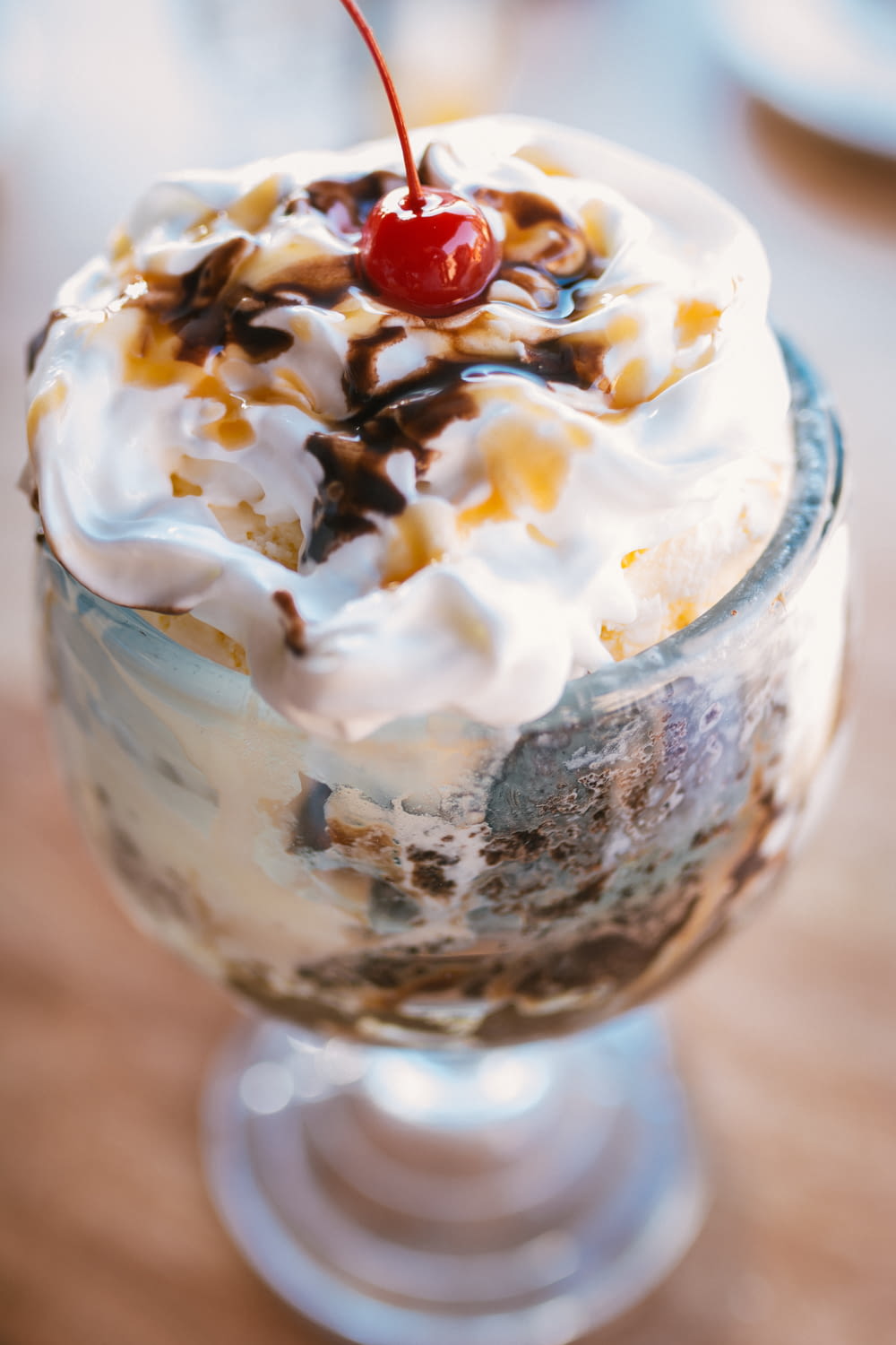 shallow focus photo of dessert on clear footed glass cup