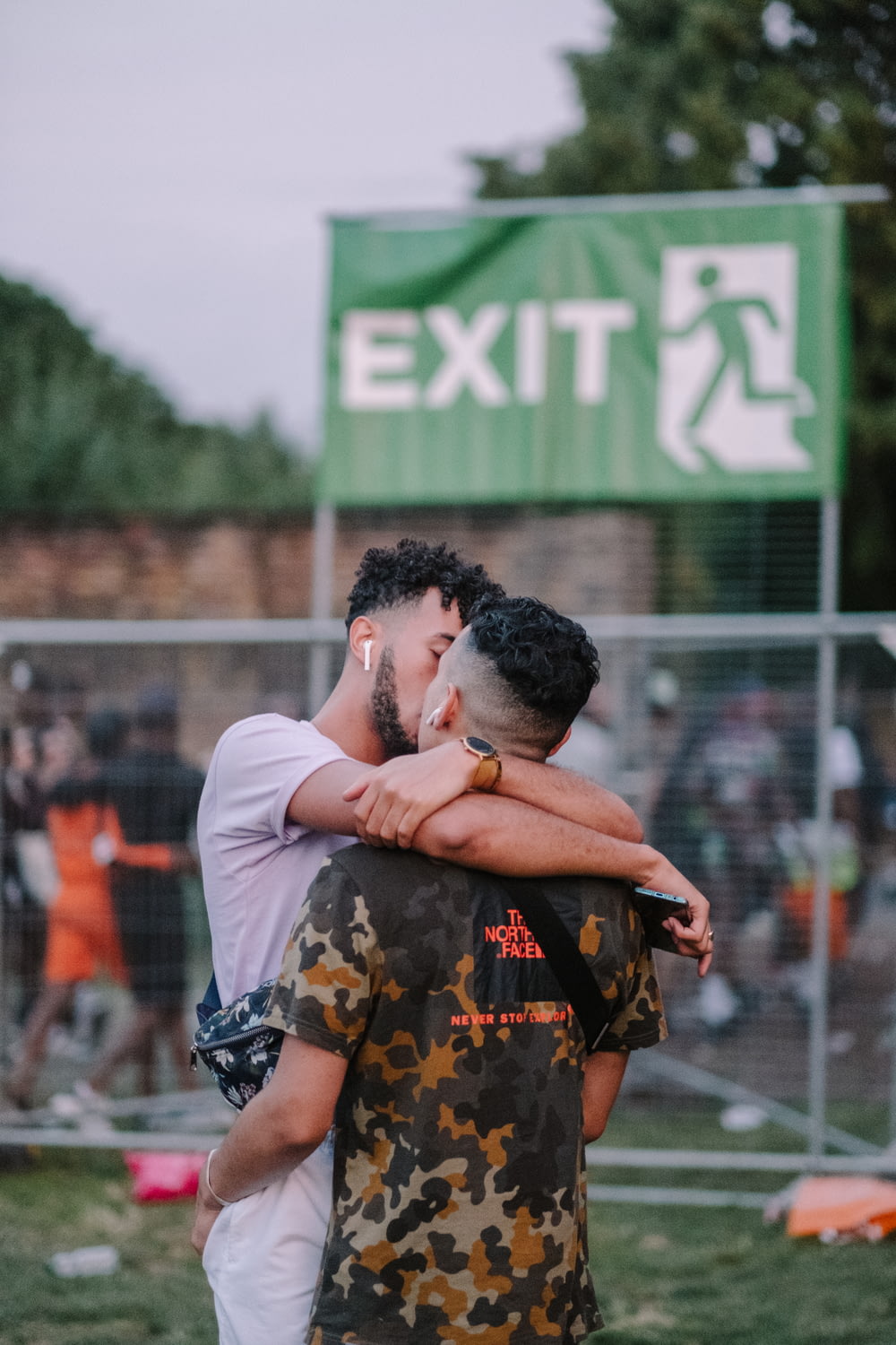 shallow focus photo of two men kissing