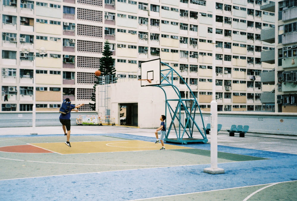 man plying basketball near outdoor during daytime