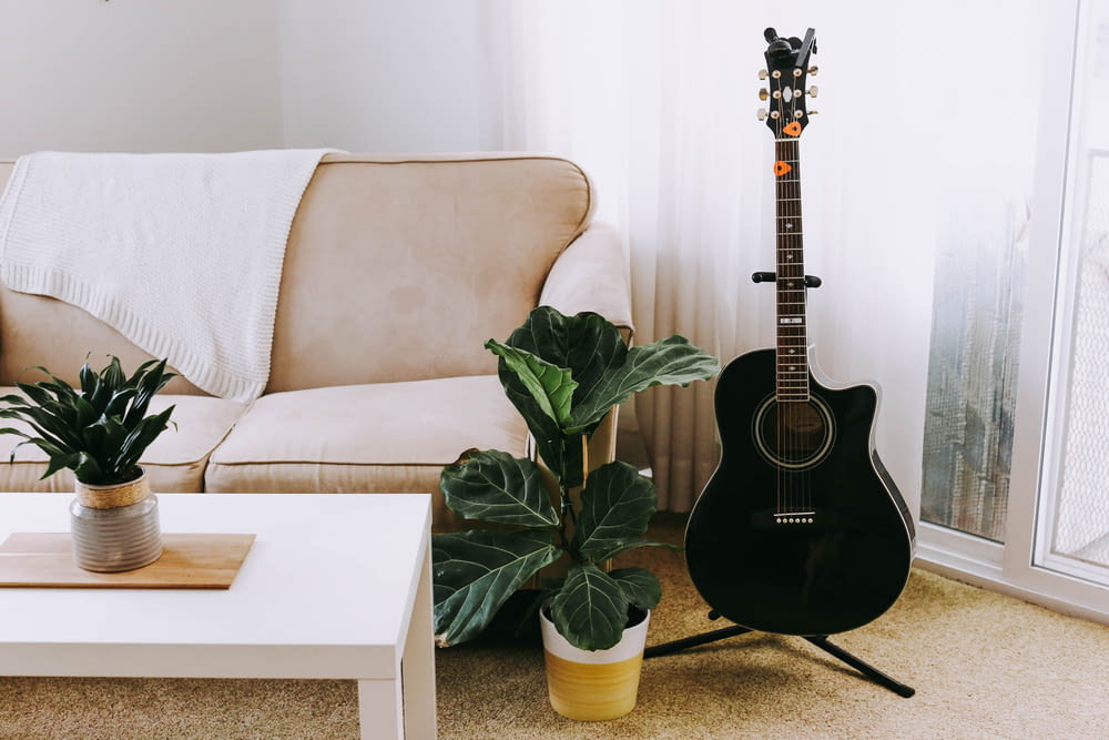a living room with a couch and a guitar