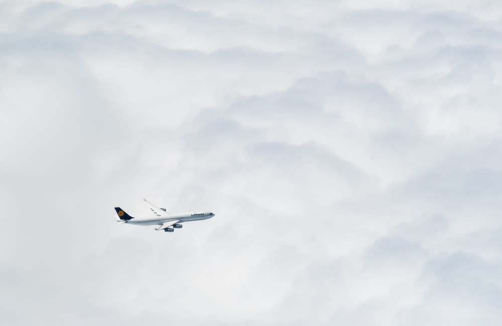 an airplane flying through the clouds in the sky