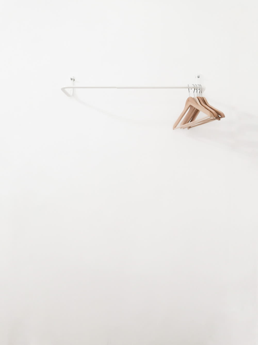 beige wooden clothes hangers