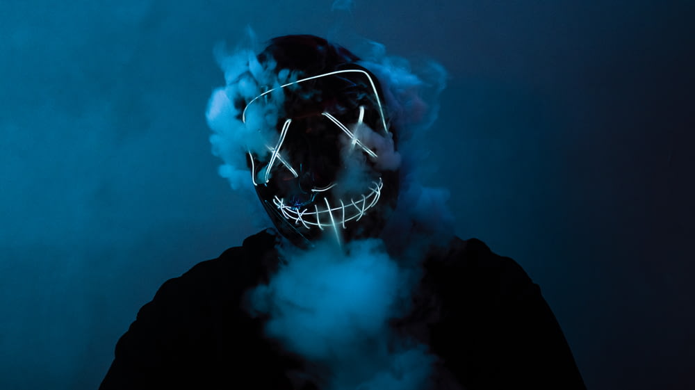 a person wearing a mask with smoke coming out of it