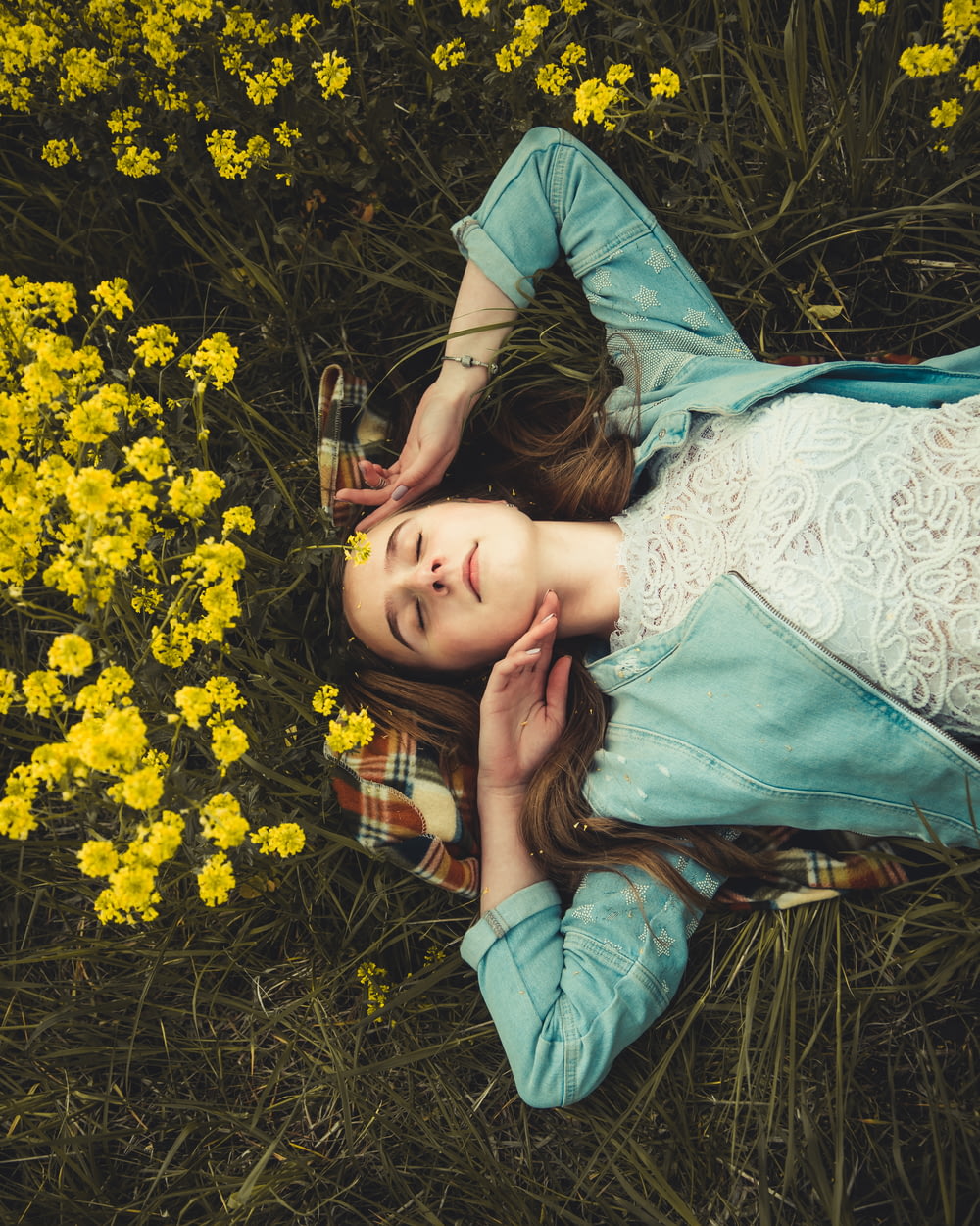 woman lying on grass field