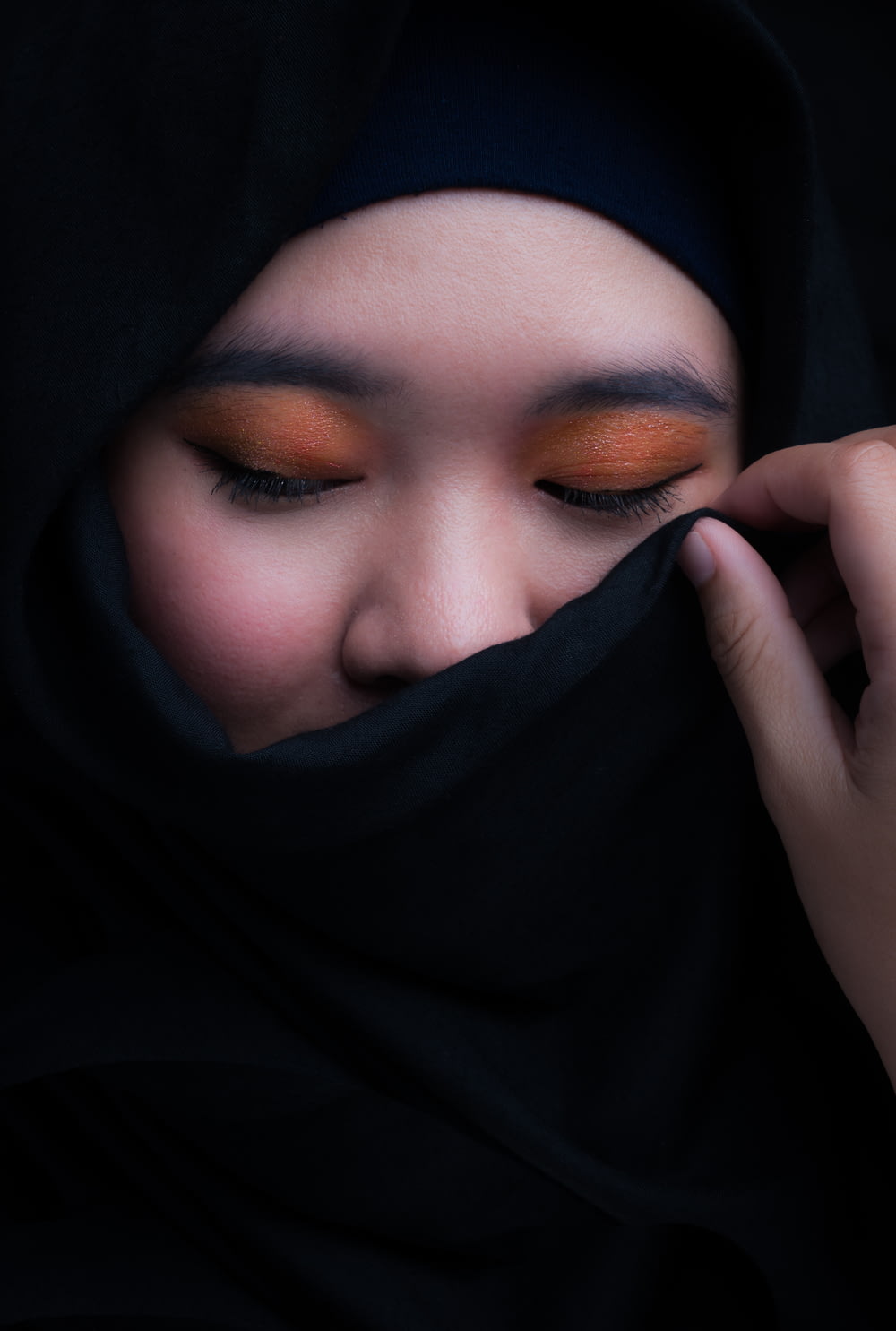woman covering her face with black hijab