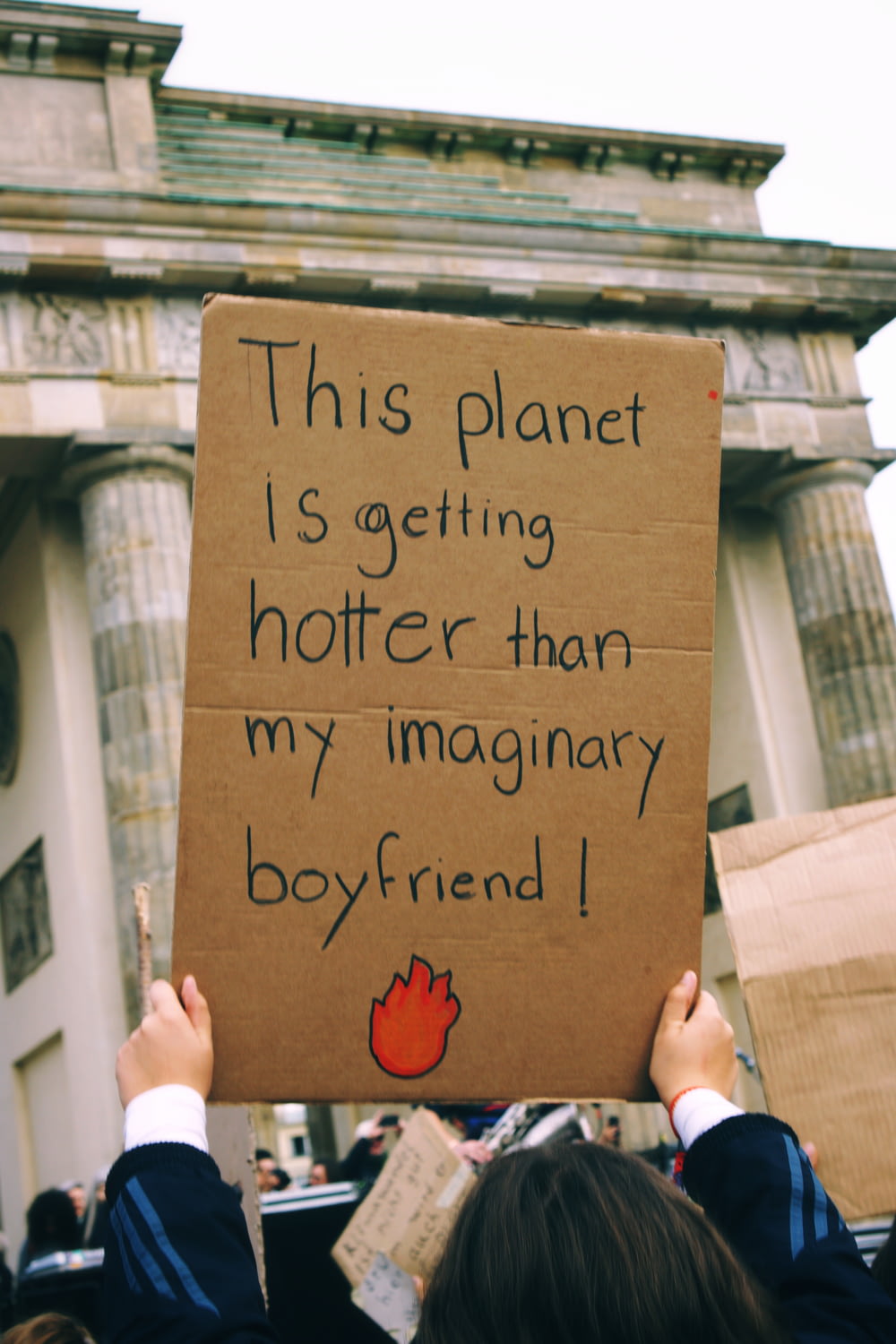a person holding a sign that says this planet is getting shorter than my imaginary boyfriend