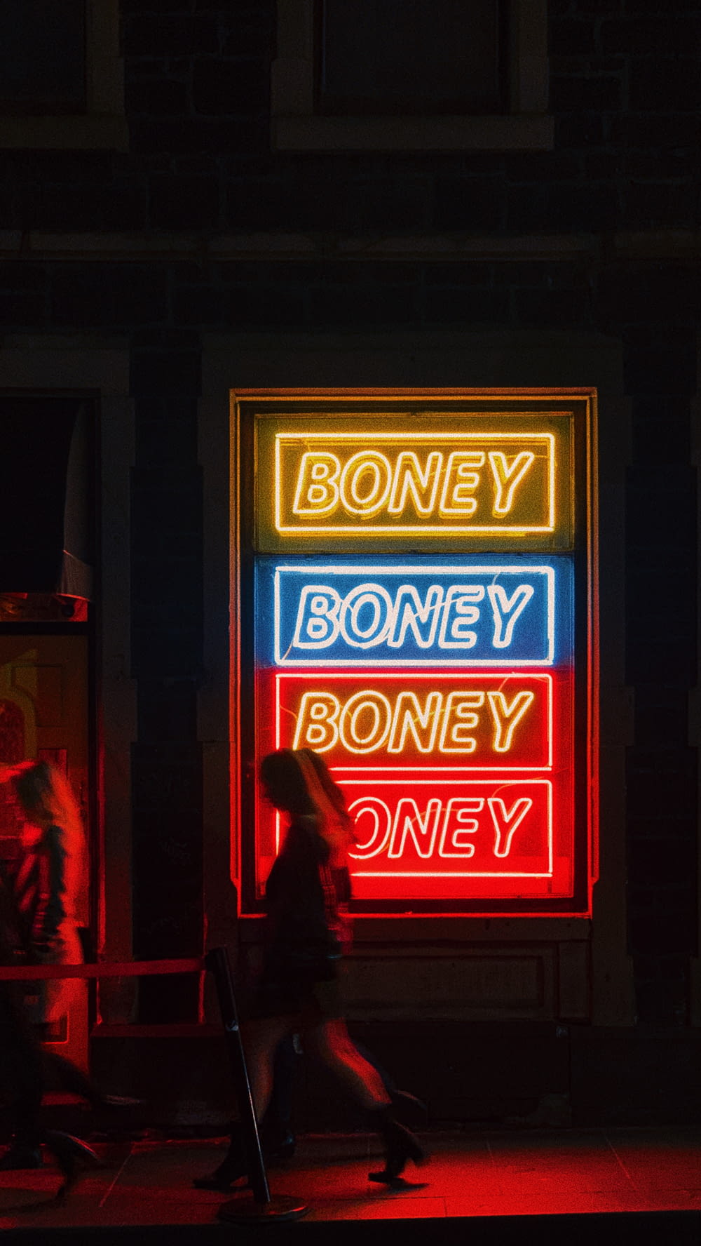 a neon sign that says honey, boney, boney, and oney