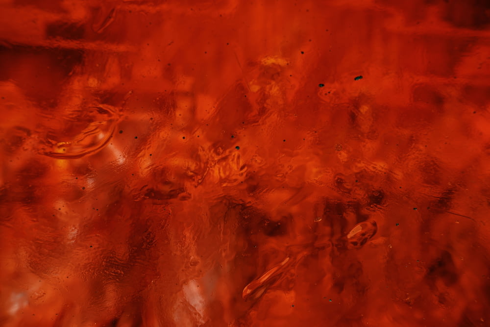 a close up of a red glass surface