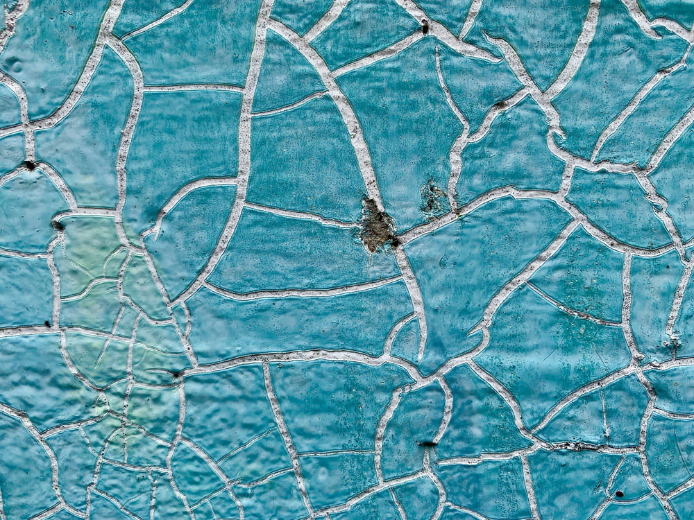 a close up of a blue wall with white lines on it