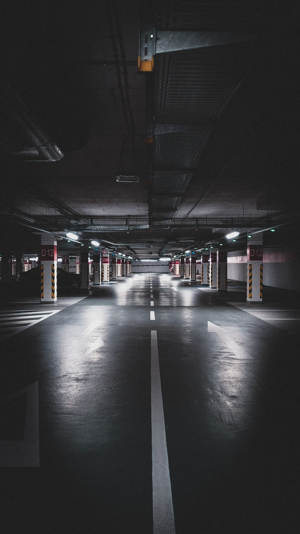 an empty parking garage at night with lights on