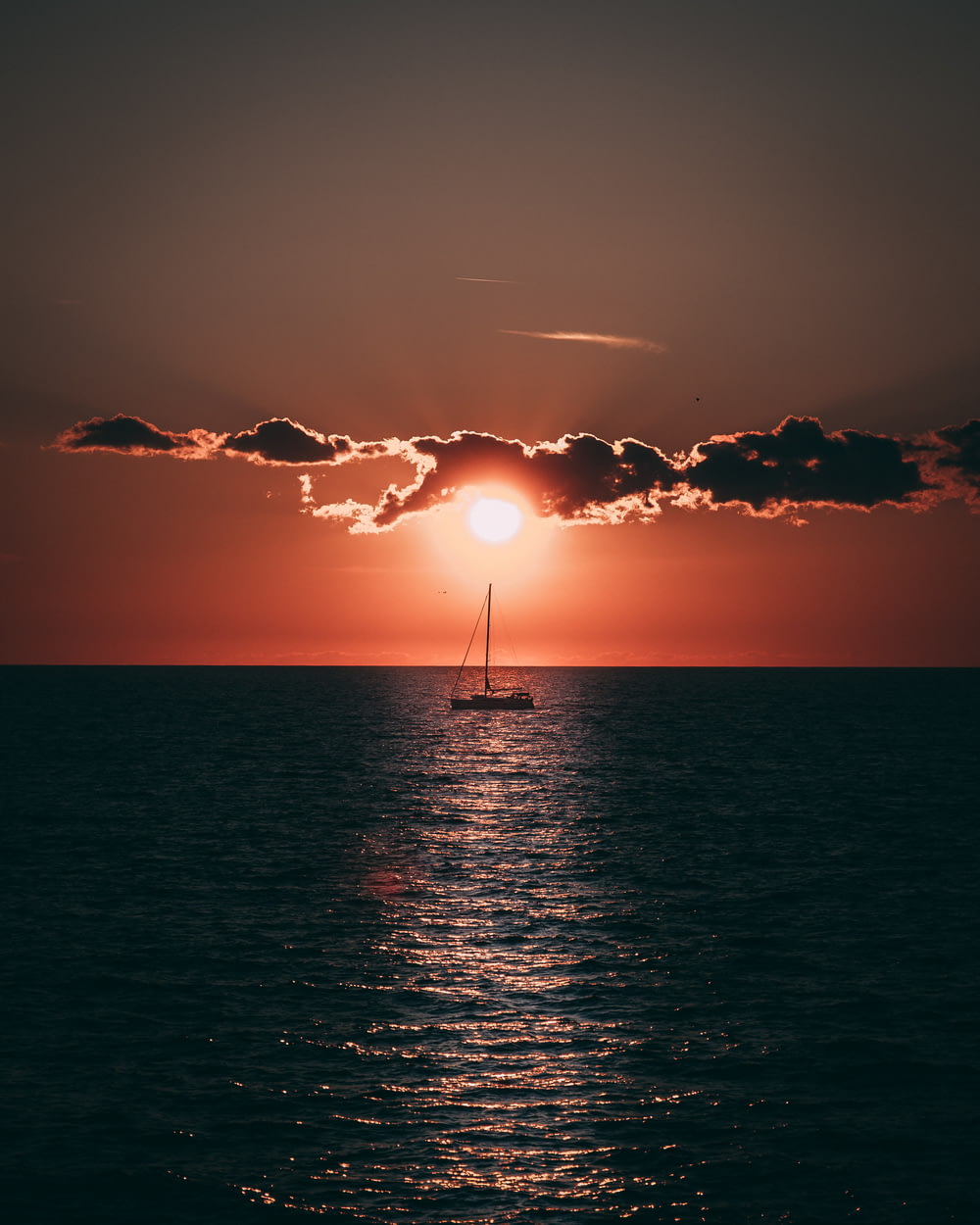 sailboat in sea during golden hour