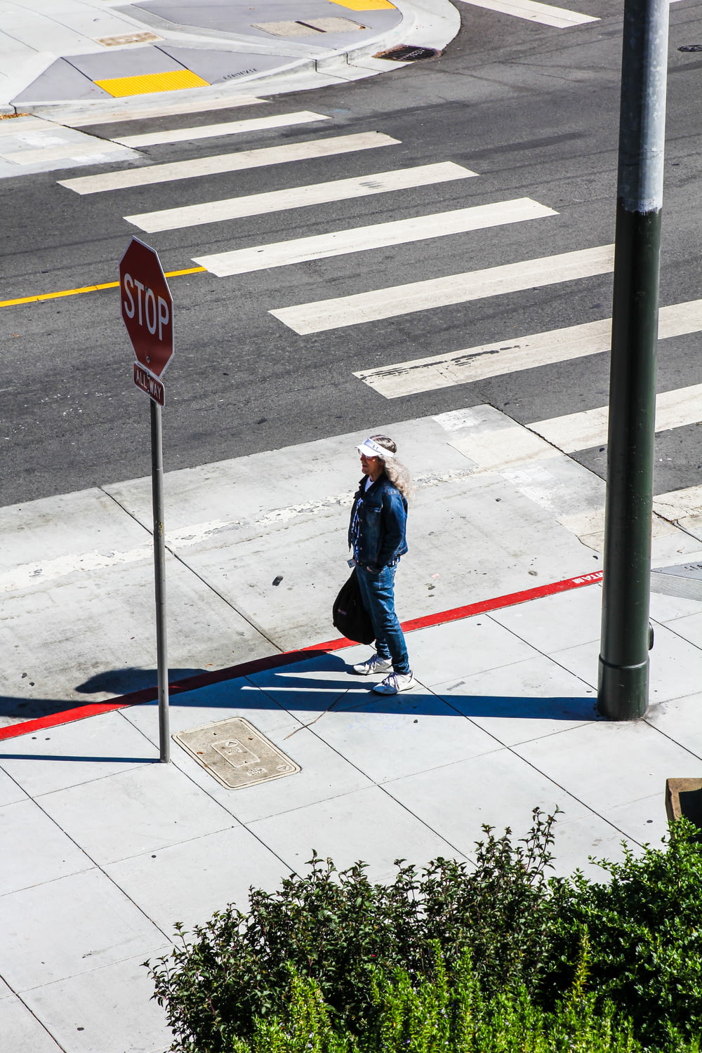 woman walking on sidewalk during daytime