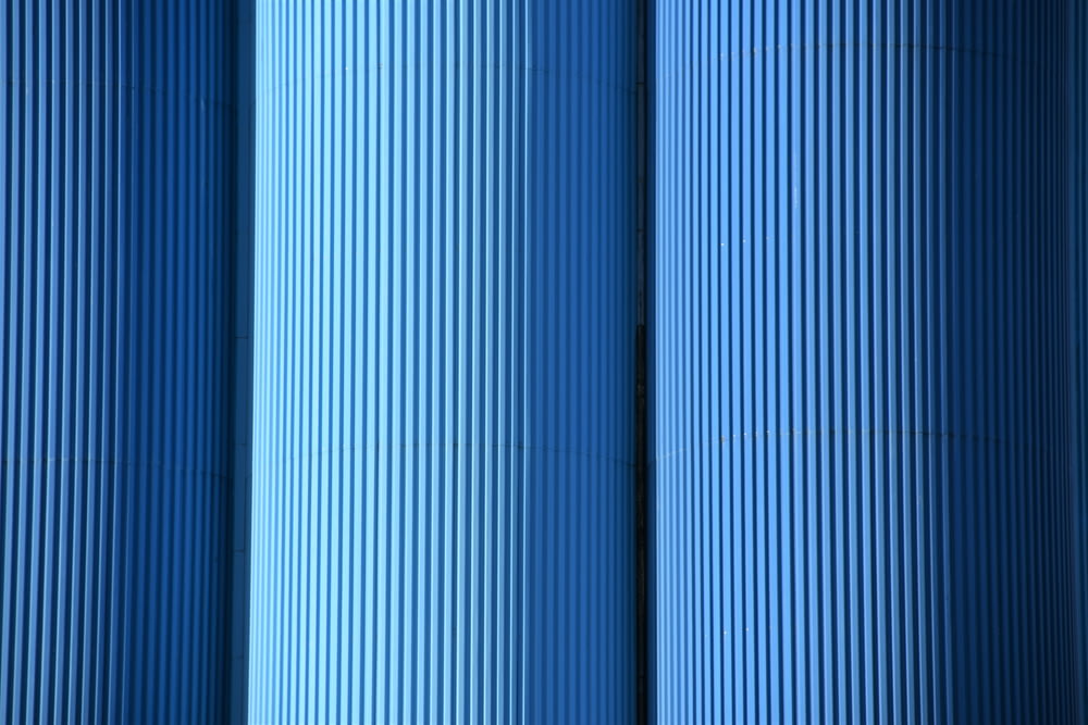a close up of a row of blue pipes