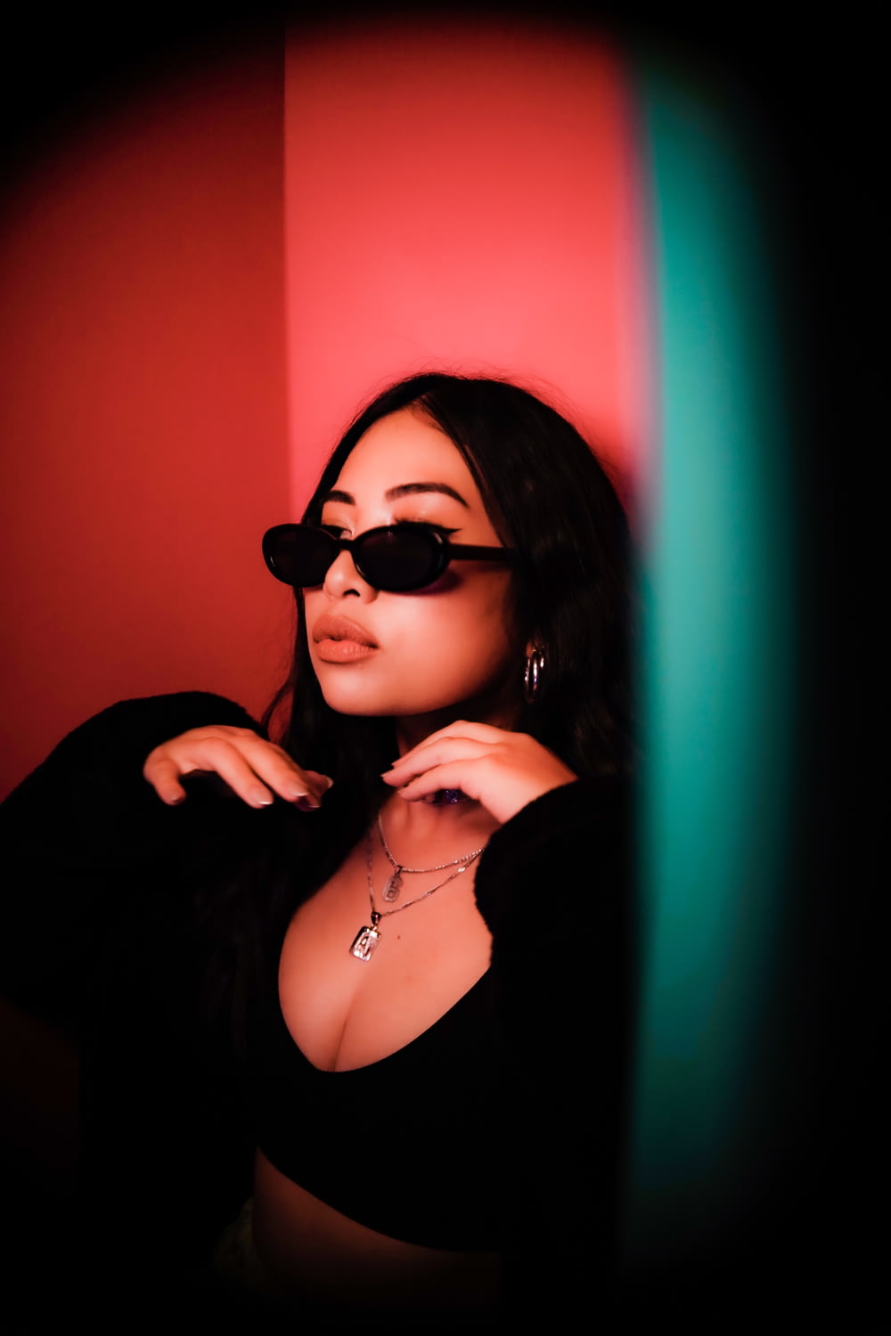 woman wearing black sunglasses leaning on wall