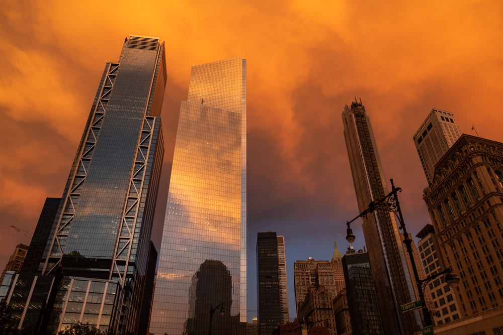 low-angle photography of high-rise buildings during sunset