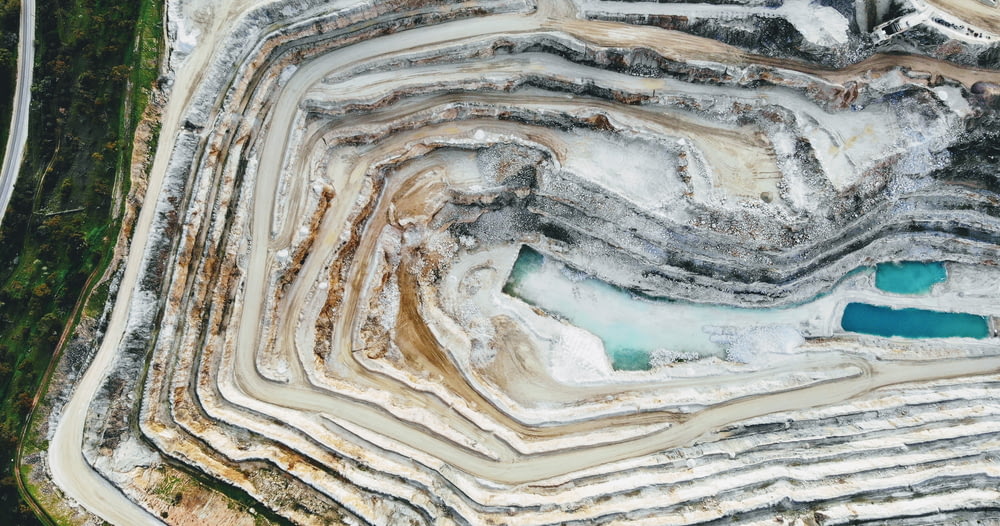 an aerial view of a quarry with a blue pool