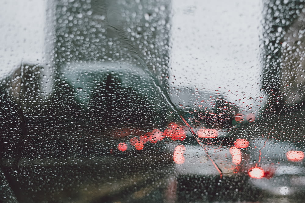 a view of a street through a rain covered window