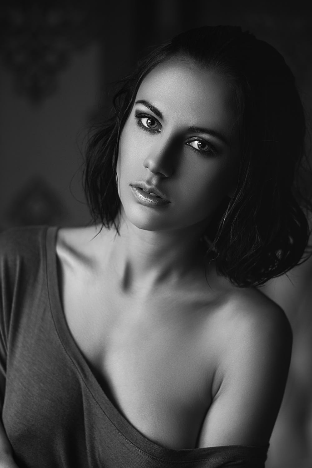 grayscale photo of woman in off-shoulder shirt