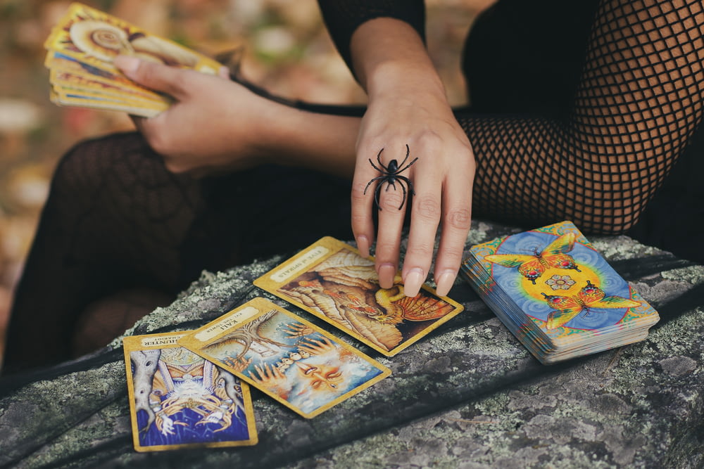 woman holding tarot cards