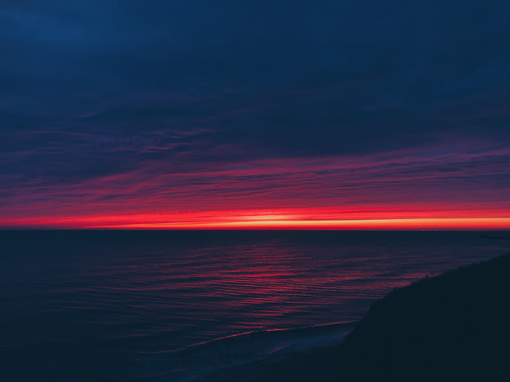 calm body of water during horizon