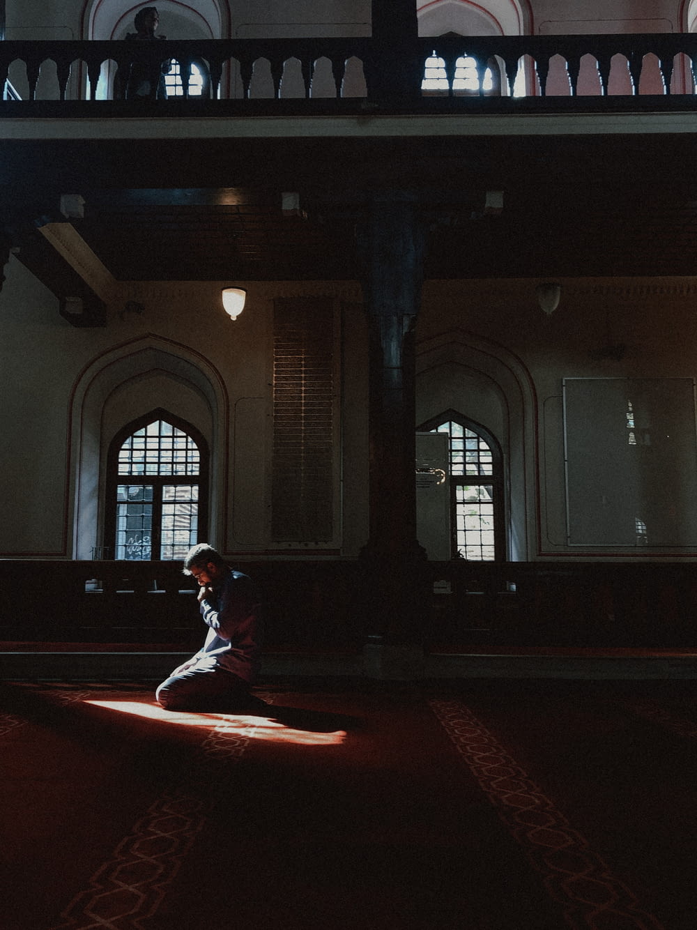 man kneeling on red floor