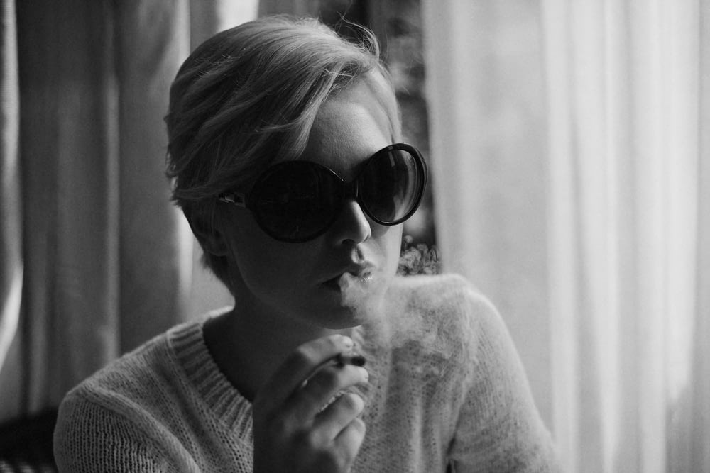 woman wears sunglasses and smoking photograph