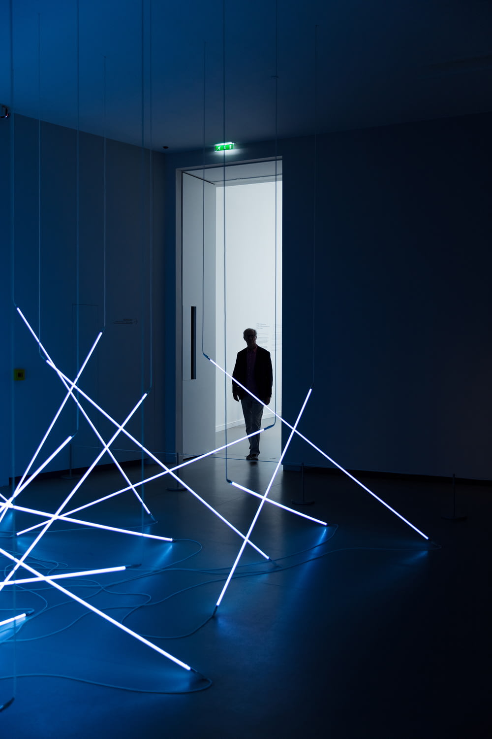person at a white room with flourescent lights