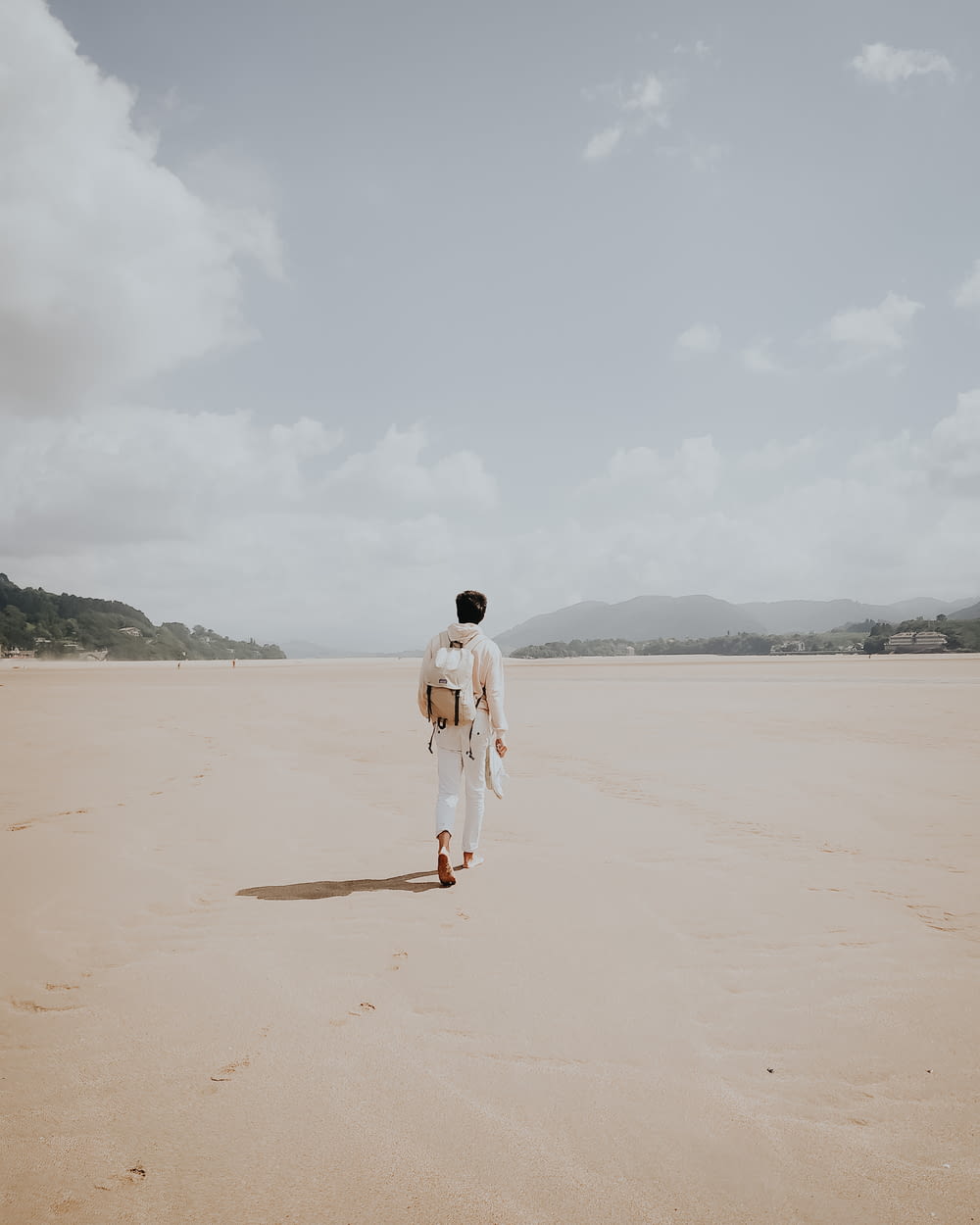 man walking on brown sand