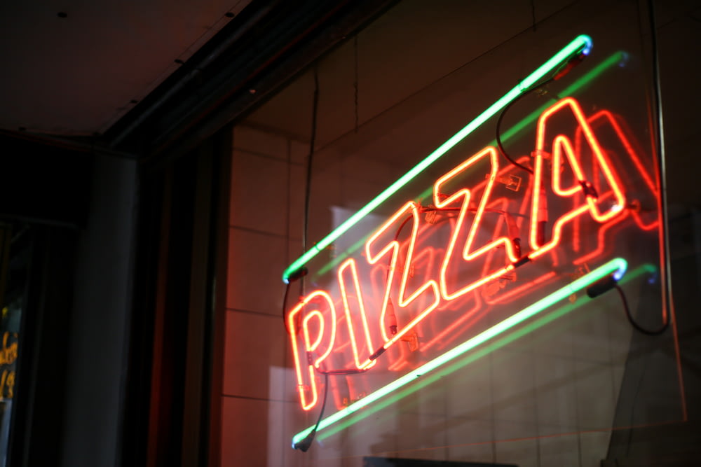 shallow focus photo of lighted pizza neon light signage
