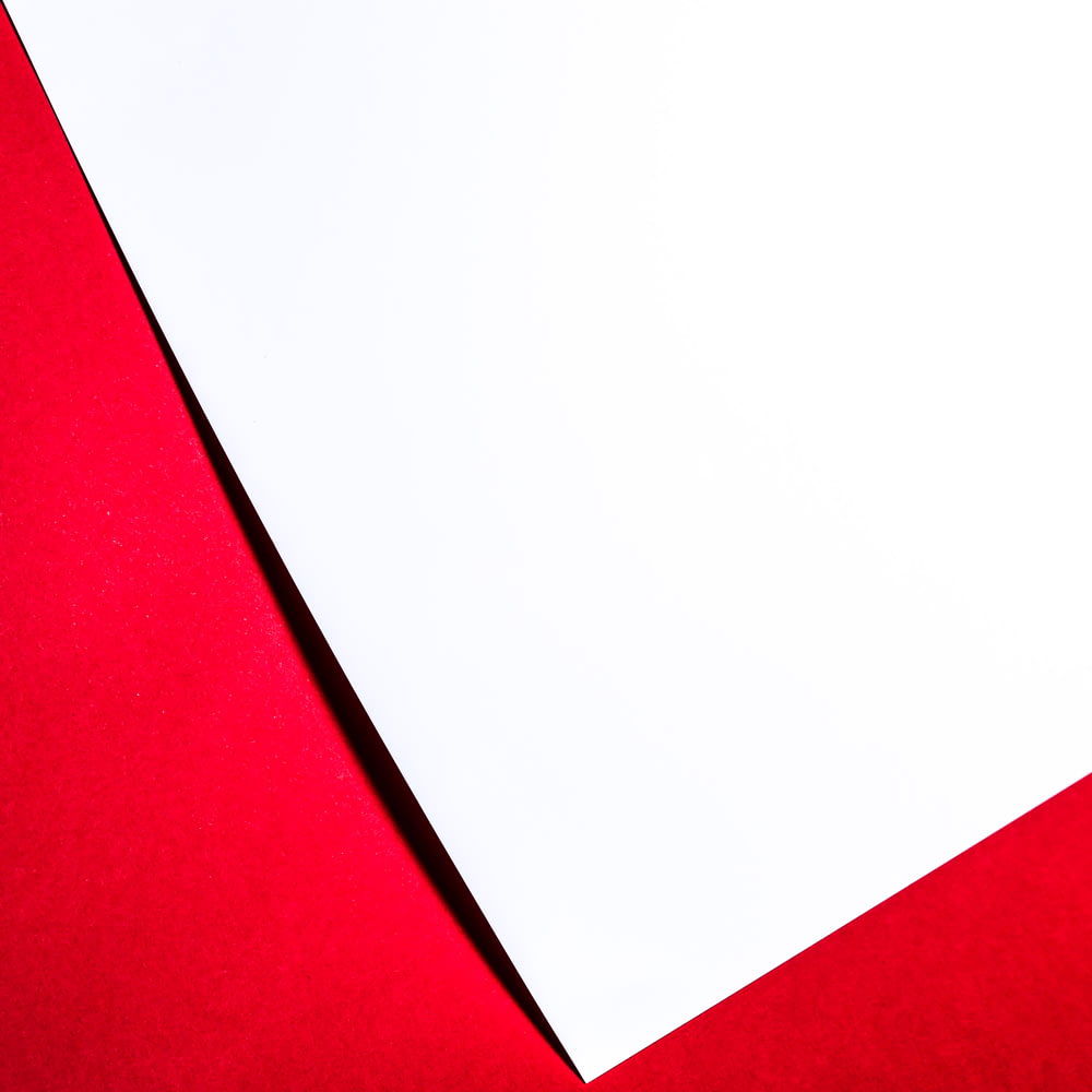 a close up of a piece of paper on a red surface