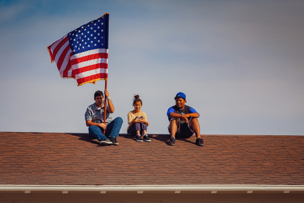 men and woman sitting on roof top