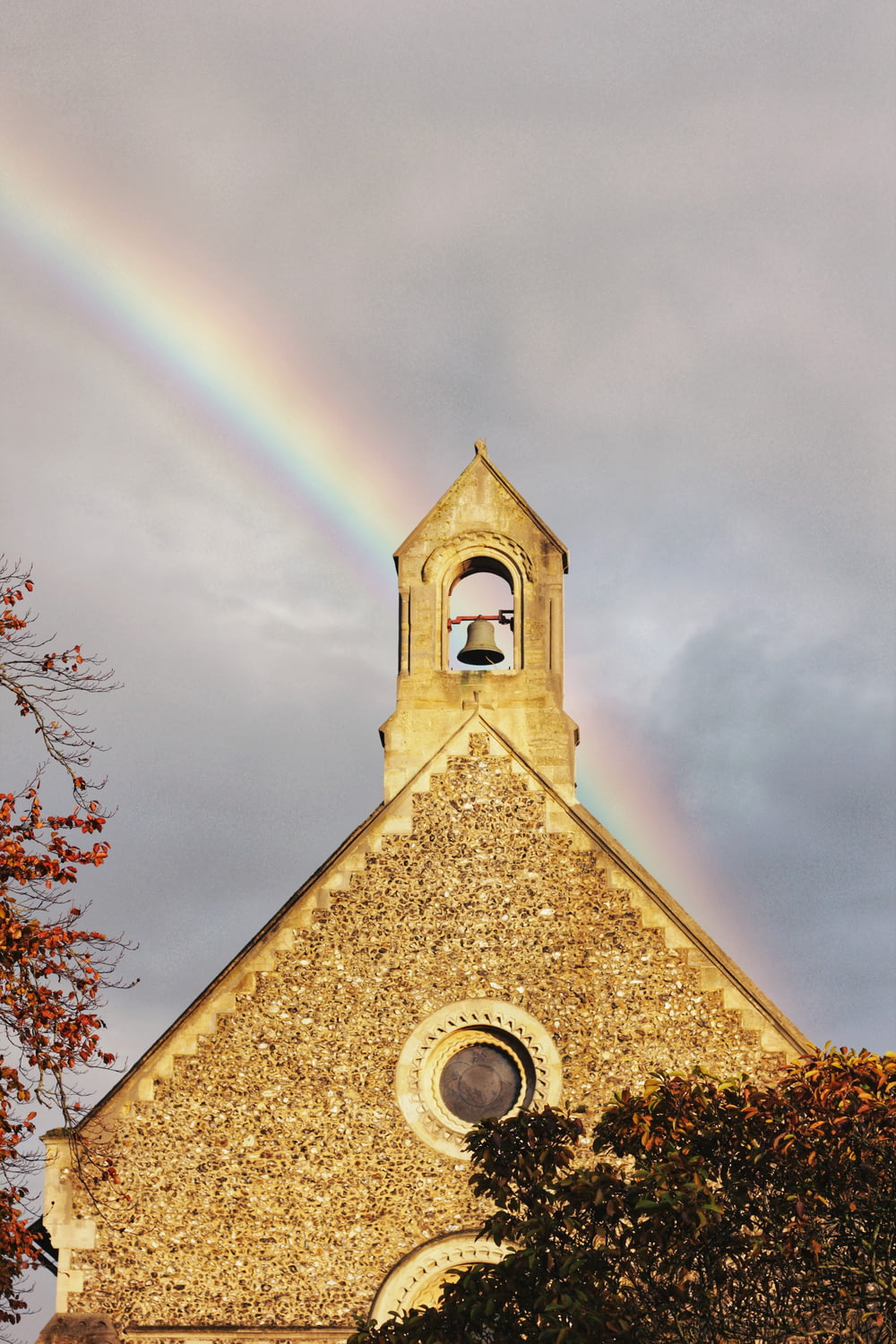 brown church under rainbow
