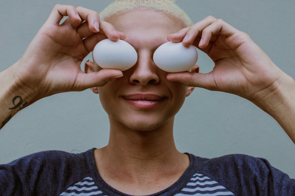 woman holding two white eggs