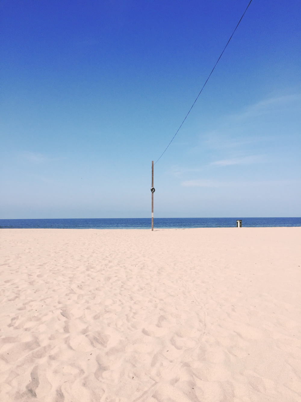 gray pole on seashore during daytime