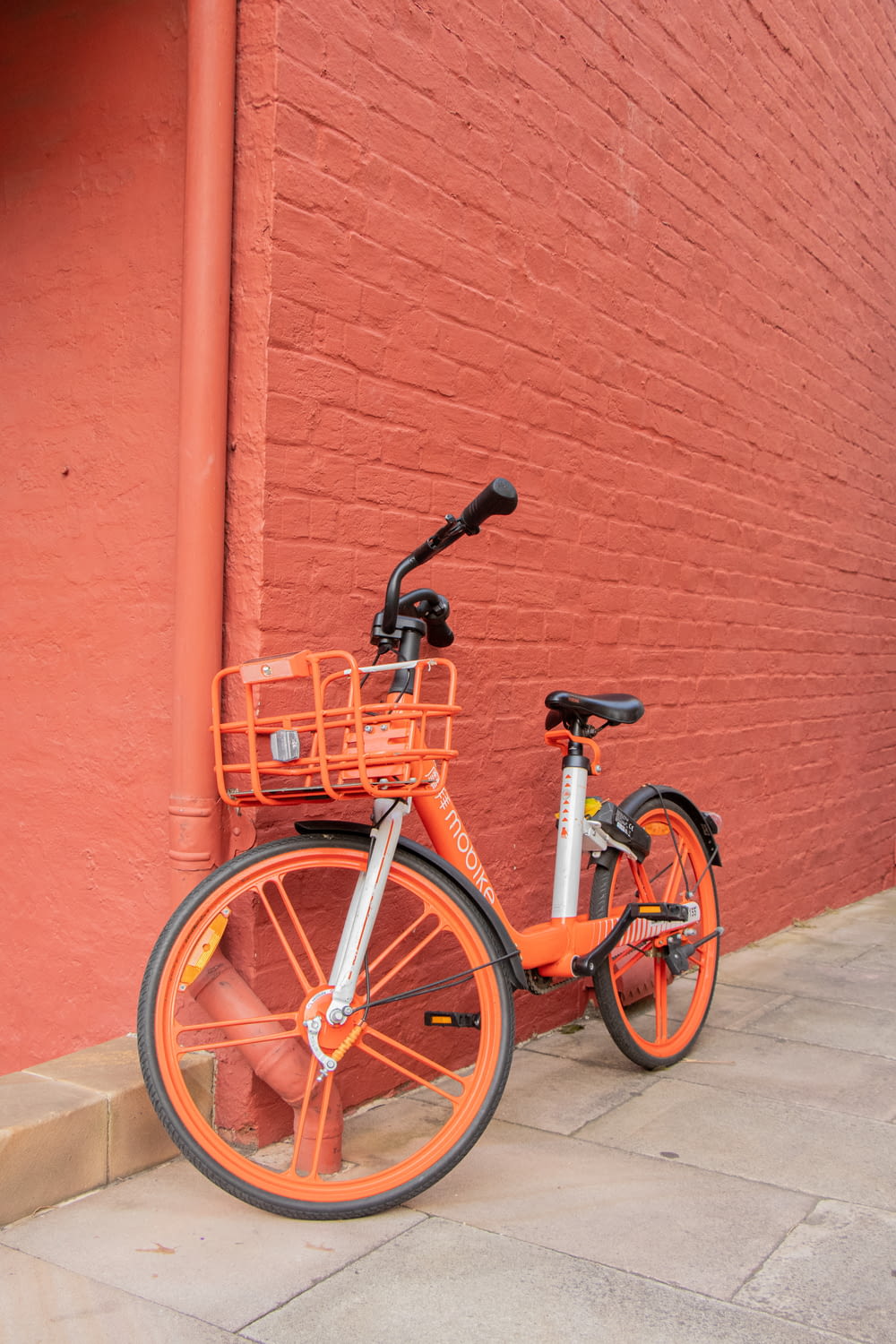 parked orange and white bicycle