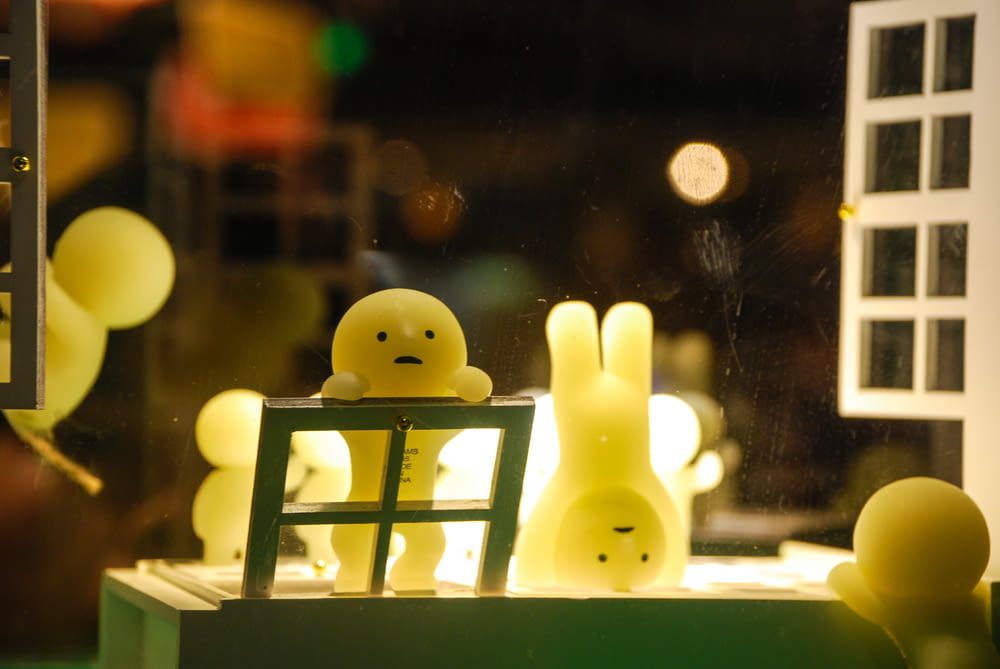 a couple of little yellow bunnies sitting on top of a table