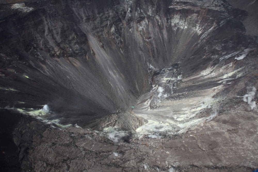 an aerial view of a large crater in the mountains