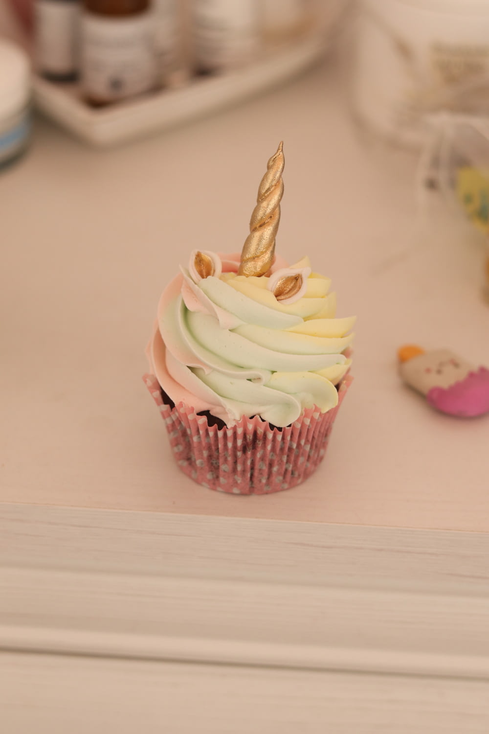 a cupcake with a unicorn horn on top of it