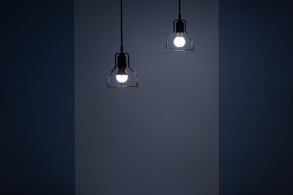 two turned on pendant lamps