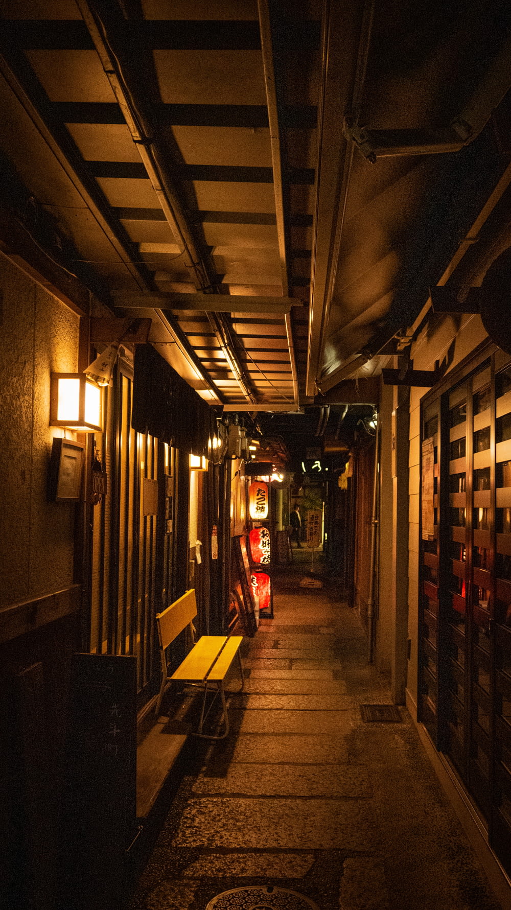 narrow pathway lighted with sconces